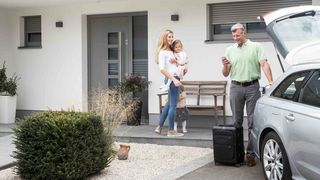 Familie vor Haus mit Rollläden Familie mit Auto vor Haus mit Rollläden